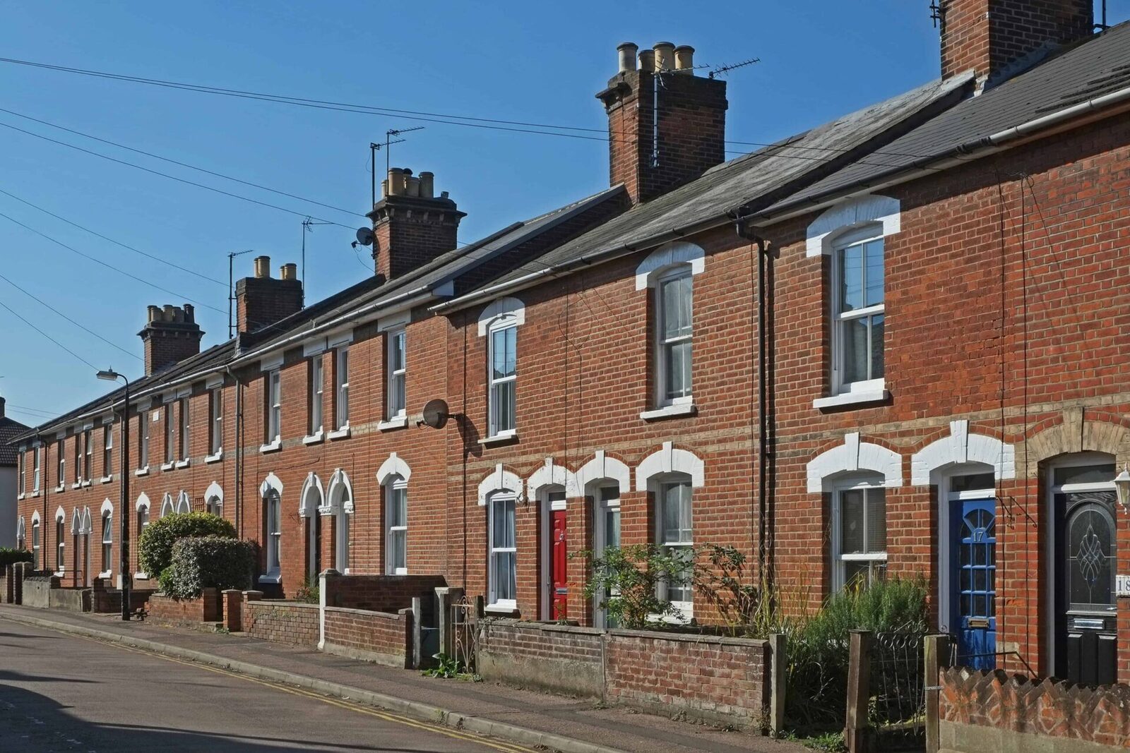Traditional UK terraced brick houses on a residential street